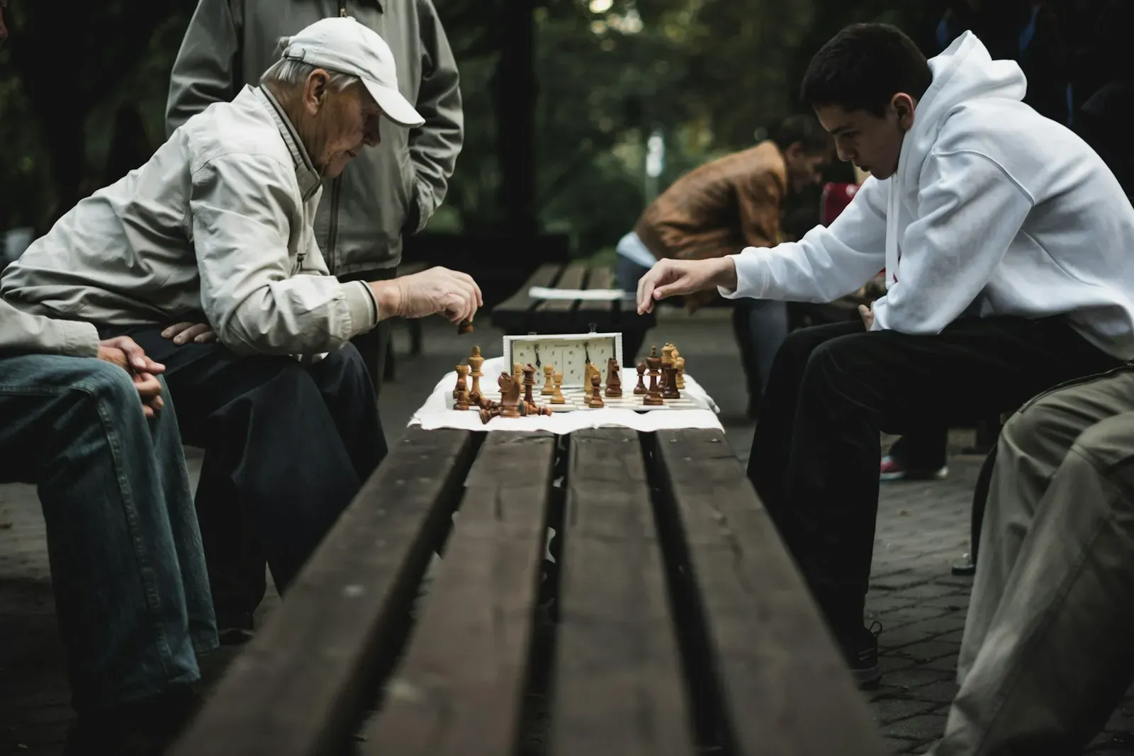 Two players and a chess clock in a park (photo by Tanner Mardis on Unsplash)