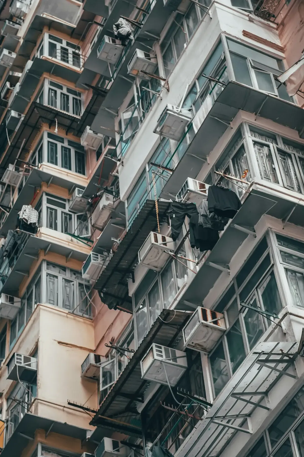 Densely packed apartment facades in Hong Kong (photo by I P on Unsplash)